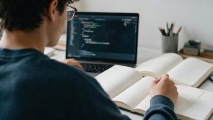 STEM student organizing project notes and code on a laptop